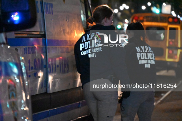 Crime scene investigators with the NYPD mark evidence at the scene and a vehicle with bullet holes where a 29-year-old man is shot in the ch...