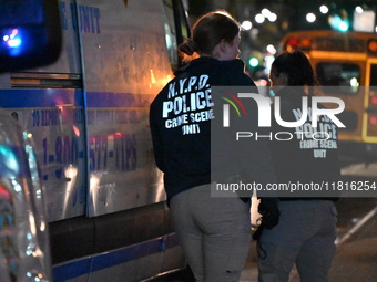 Crime scene investigators with the NYPD mark evidence at the scene and a vehicle with bullet holes where a 29-year-old man is shot in the ch...