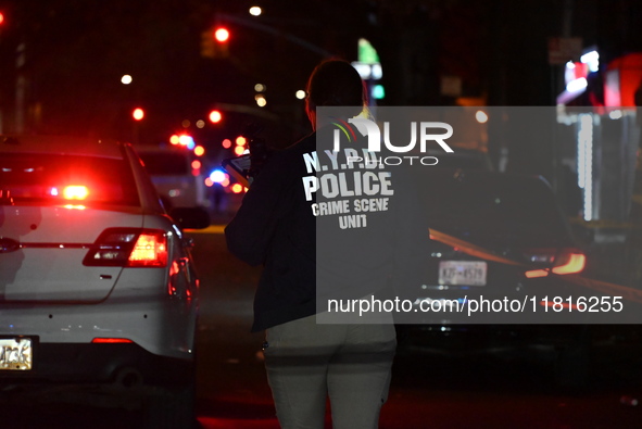 Crime scene investigators with the NYPD mark evidence at the scene and a vehicle with bullet holes where a 29-year-old man is shot in the ch...