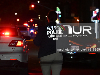 Crime scene investigators with the NYPD mark evidence at the scene and a vehicle with bullet holes where a 29-year-old man is shot in the ch...