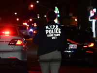 Crime scene investigators with the NYPD mark evidence at the scene and a vehicle with bullet holes where a 29-year-old man is shot in the ch...