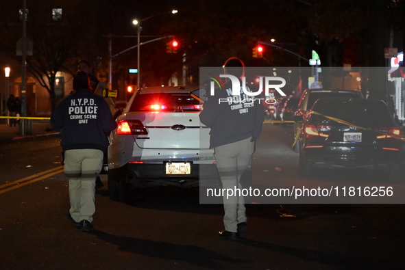 Crime scene investigators with the NYPD mark evidence at the scene and a vehicle with bullet holes where a 29-year-old man is shot in the ch...