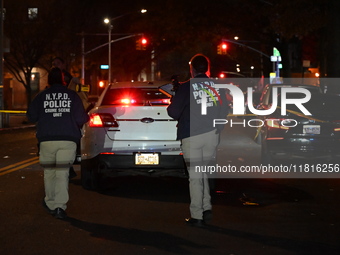 Crime scene investigators with the NYPD mark evidence at the scene and a vehicle with bullet holes where a 29-year-old man is shot in the ch...