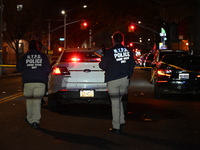 Crime scene investigators with the NYPD mark evidence at the scene and a vehicle with bullet holes where a 29-year-old man is shot in the ch...