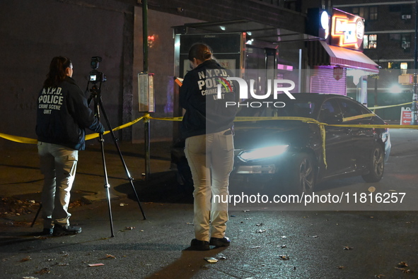 Crime scene investigators with the NYPD mark evidence at the scene and a vehicle with bullet holes where a 29-year-old man is shot in the ch...