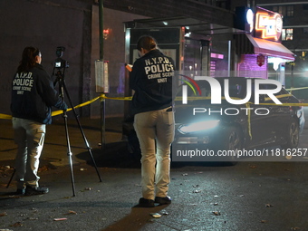 Crime scene investigators with the NYPD mark evidence at the scene and a vehicle with bullet holes where a 29-year-old man is shot in the ch...