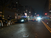 Crime scene investigators with the NYPD mark evidence at the scene and a vehicle with bullet holes where a 29-year-old man is shot in the ch...