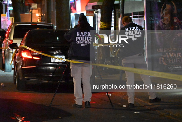 Crime scene investigators with the NYPD mark evidence at the scene and a vehicle with bullet holes where a 29-year-old man is shot in the ch...