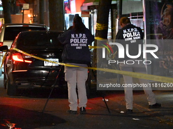 Crime scene investigators with the NYPD mark evidence at the scene and a vehicle with bullet holes where a 29-year-old man is shot in the ch...