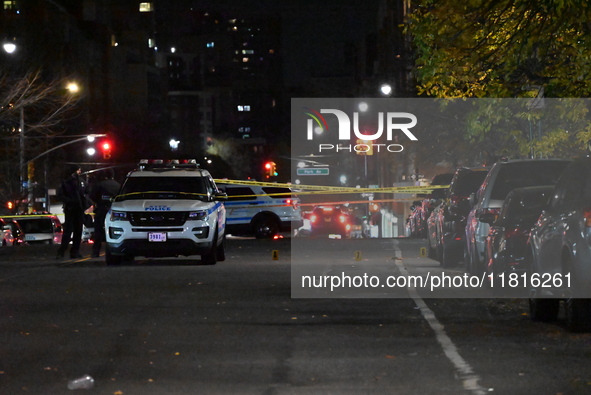 Crime scene investigators with the NYPD mark evidence at the scene and a vehicle with bullet holes where a 29-year-old man is shot in the ch...