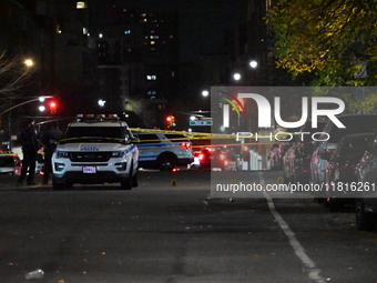 Crime scene investigators with the NYPD mark evidence at the scene and a vehicle with bullet holes where a 29-year-old man is shot in the ch...