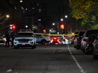 Crime scene investigators with the NYPD mark evidence at the scene and a vehicle with bullet holes where a 29-year-old man is shot in the ch...