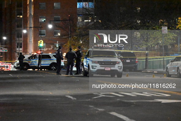 Crime scene investigators with the NYPD mark evidence at the scene and a vehicle with bullet holes where a 29-year-old man is shot in the ch...