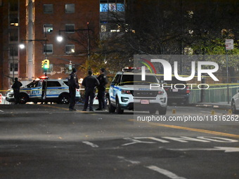 Crime scene investigators with the NYPD mark evidence at the scene and a vehicle with bullet holes where a 29-year-old man is shot in the ch...