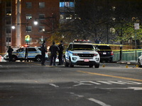 Crime scene investigators with the NYPD mark evidence at the scene and a vehicle with bullet holes where a 29-year-old man is shot in the ch...