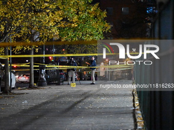 Crime scene investigators with the NYPD mark evidence at the scene and a vehicle with bullet holes where a 29-year-old man is shot in the ch...