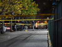 Crime scene investigators with the NYPD mark evidence at the scene and a vehicle with bullet holes where a 29-year-old man is shot in the ch...