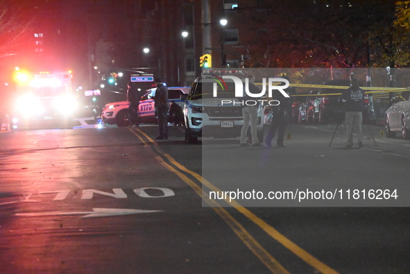 Crime scene investigators with the NYPD mark evidence at the scene and a vehicle with bullet holes where a 29-year-old man is shot in the ch...