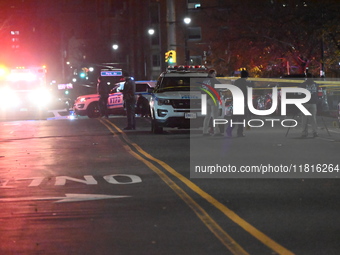 Crime scene investigators with the NYPD mark evidence at the scene and a vehicle with bullet holes where a 29-year-old man is shot in the ch...