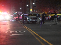 Crime scene investigators with the NYPD mark evidence at the scene and a vehicle with bullet holes where a 29-year-old man is shot in the ch...