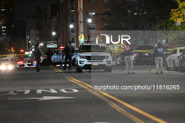 Crime scene investigators with the NYPD mark evidence at the scene and a vehicle with bullet holes where a 29-year-old man is shot in the ch...