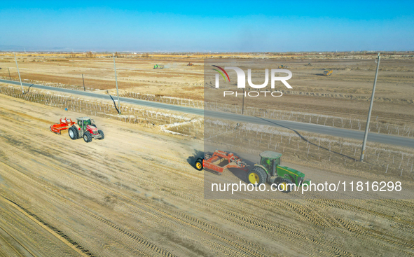 Large machinery levels the land at a high-standard farmland construction site in Weili County, Bayingoleng Mongolian Autonomous Prefecture,...