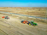 Large machinery levels the land at a high-standard farmland construction site in Weili County, Bayingoleng Mongolian Autonomous Prefecture,...