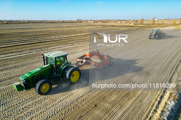 Large machinery levels the land at a high-standard farmland construction site in Weili County, Bayingoleng Mongolian Autonomous Prefecture,...