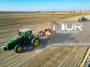 Large machinery levels the land at a high-standard farmland construction site in Weili County, Bayingoleng Mongolian Autonomous Prefecture,...