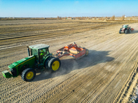 Large machinery levels the land at a high-standard farmland construction site in Weili County, Bayingoleng Mongolian Autonomous Prefecture,...