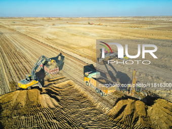 Large machinery levels the land at a high-standard farmland construction site in Weili County, Bayingoleng Mongolian Autonomous Prefecture,...