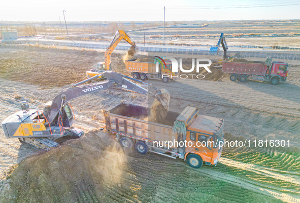 Large machinery levels the land at a high-standard farmland construction site in Weili County, Bayingoleng Mongolian Autonomous Prefecture,...