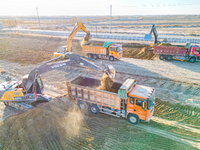 Large machinery levels the land at a high-standard farmland construction site in Weili County, Bayingoleng Mongolian Autonomous Prefecture,...