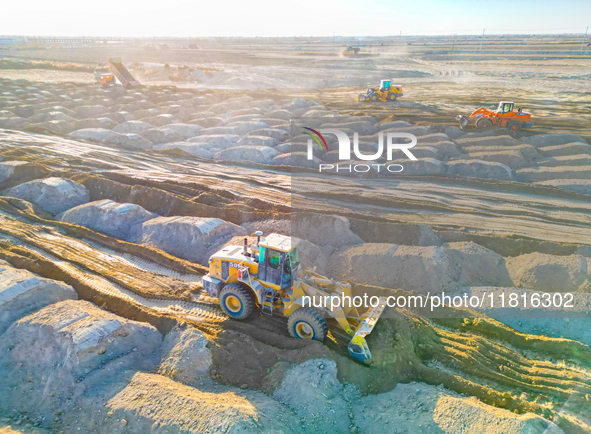 Large machinery levels the land at a high-standard farmland construction site in Weili County, Bayingoleng Mongolian Autonomous Prefecture,...