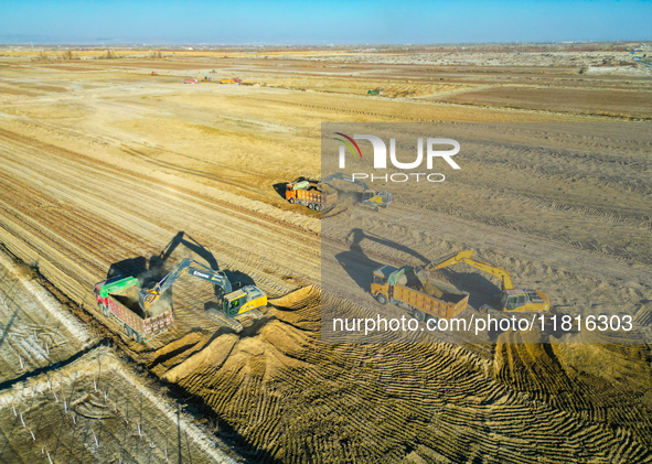 Large machinery levels the land at a high-standard farmland construction site in Weili County, Bayingoleng Mongolian Autonomous Prefecture,...