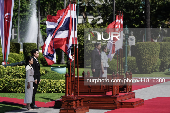 Singapore's Prime Minister Lawrence Wong and Thailand's Prime Minister Paetongtarn Shinawatra review the guard of honor during a welcoming c...