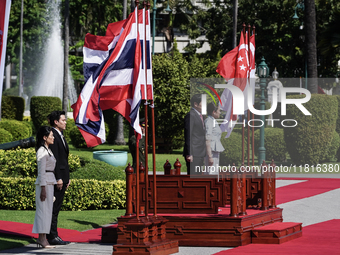 Singapore's Prime Minister Lawrence Wong and Thailand's Prime Minister Paetongtarn Shinawatra review the guard of honor during a welcoming c...