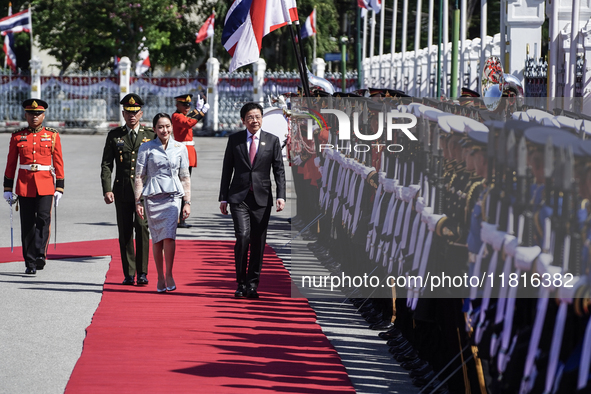 Singapore's Prime Minister Lawrence Wong and Thailand's Prime Minister Paetongtarn Shinawatra review the guard of honor during a welcoming c...