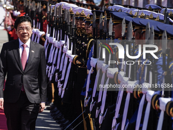 Singapore's Prime Minister Lawrence Wong reviews the guard of honor during a welcoming ceremony at Government House in Bangkok, Thailand, on...