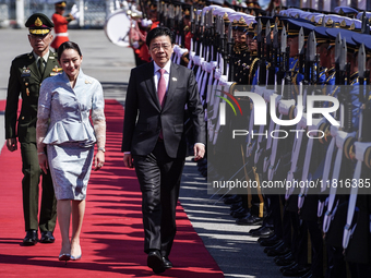 Singapore's Prime Minister Lawrence Wong and Thailand's Prime Minister Paetongtarn Shinawatra review the guard of honor during a welcoming c...