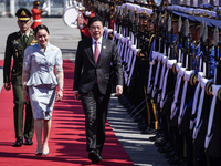 Singapore's Prime Minister Lawrence Wong and Thailand's Prime Minister Paetongtarn Shinawatra review the guard of honor during a welcoming c...