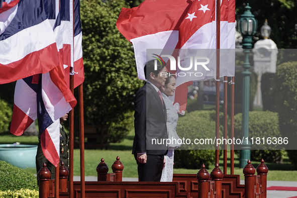 Singapore's Prime Minister Lawrence Wong and Thailand's Prime Minister Paetongtarn Shinawatra review the guard of honor during a welcoming c...