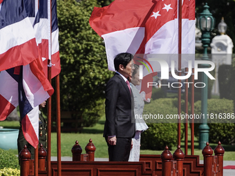 Singapore's Prime Minister Lawrence Wong and Thailand's Prime Minister Paetongtarn Shinawatra review the guard of honor during a welcoming c...