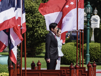 Singapore's Prime Minister Lawrence Wong and Thailand's Prime Minister Paetongtarn Shinawatra review the guard of honor during a welcoming c...