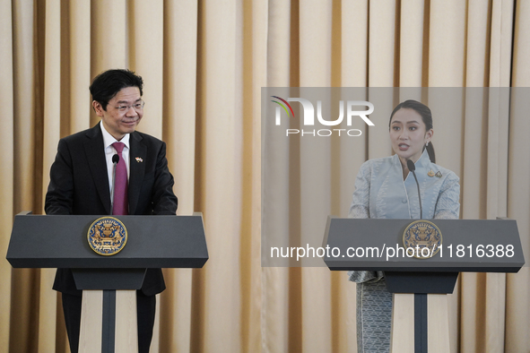 Singapore's Prime Minister Lawrence Wong speaks, and Thailand's Prime Minister Paetongtarn Shinawatra is present during a press conference a...