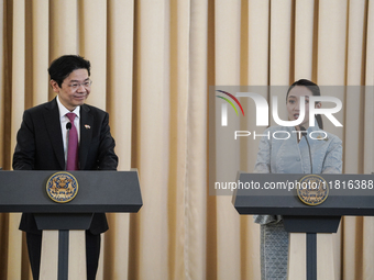 Singapore's Prime Minister Lawrence Wong speaks, and Thailand's Prime Minister Paetongtarn Shinawatra is present during a press conference a...