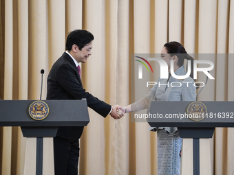 Singapore's Prime Minister Lawrence Wong shakes hands with Thailand's Prime Minister Paetongtarn Shinawatra during a press conference at Gov...