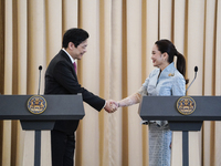 Singapore's Prime Minister Lawrence Wong shakes hands with Thailand's Prime Minister Paetongtarn Shinawatra during a press conference at Gov...