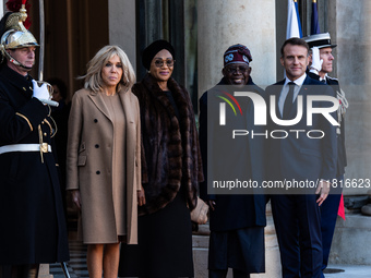 French President Emmanuel Macron and First Lady Brigitte receive Nigeria's President Bola Tinubo, who visits France for two days with the Fi...