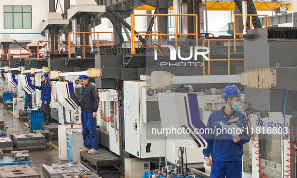 Workers produce slitting machine parts at Qingdao Kaisheng CNC Equipment Co., LTD., in Qingdao, China, on November 28, 2024. 